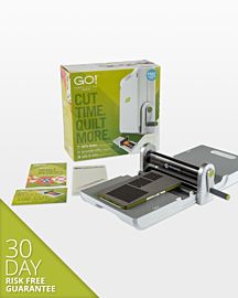 GO fabric cutter with product box, go cutting mats, die & pattern booklets on white background. 30 Day Risk Free Guarantee.
