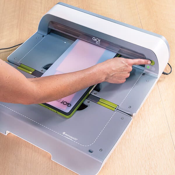 image of hand pressing a button on the GO! Big Electric Cutter