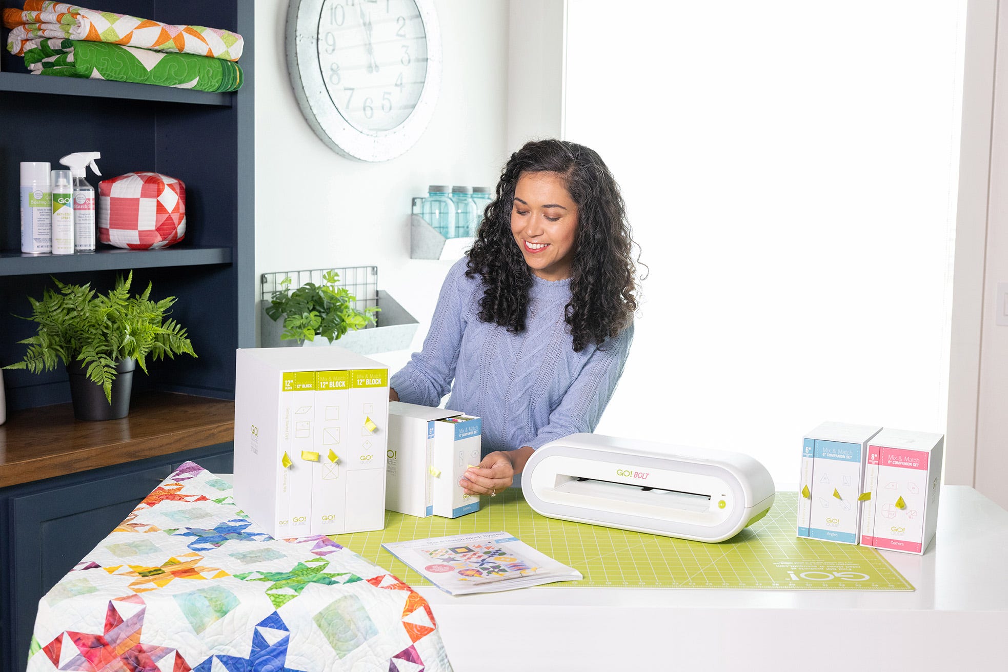 Young quilter using a GO! Me fabric cutter with adult supervision