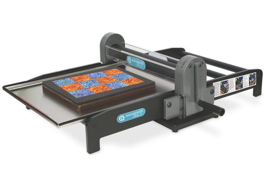 image of AccuQuilt Ready. Set. GO! Ultimate Fabric Cutting System with cutter, Qube die set, strip cutter die, cutting mat, and Qube book