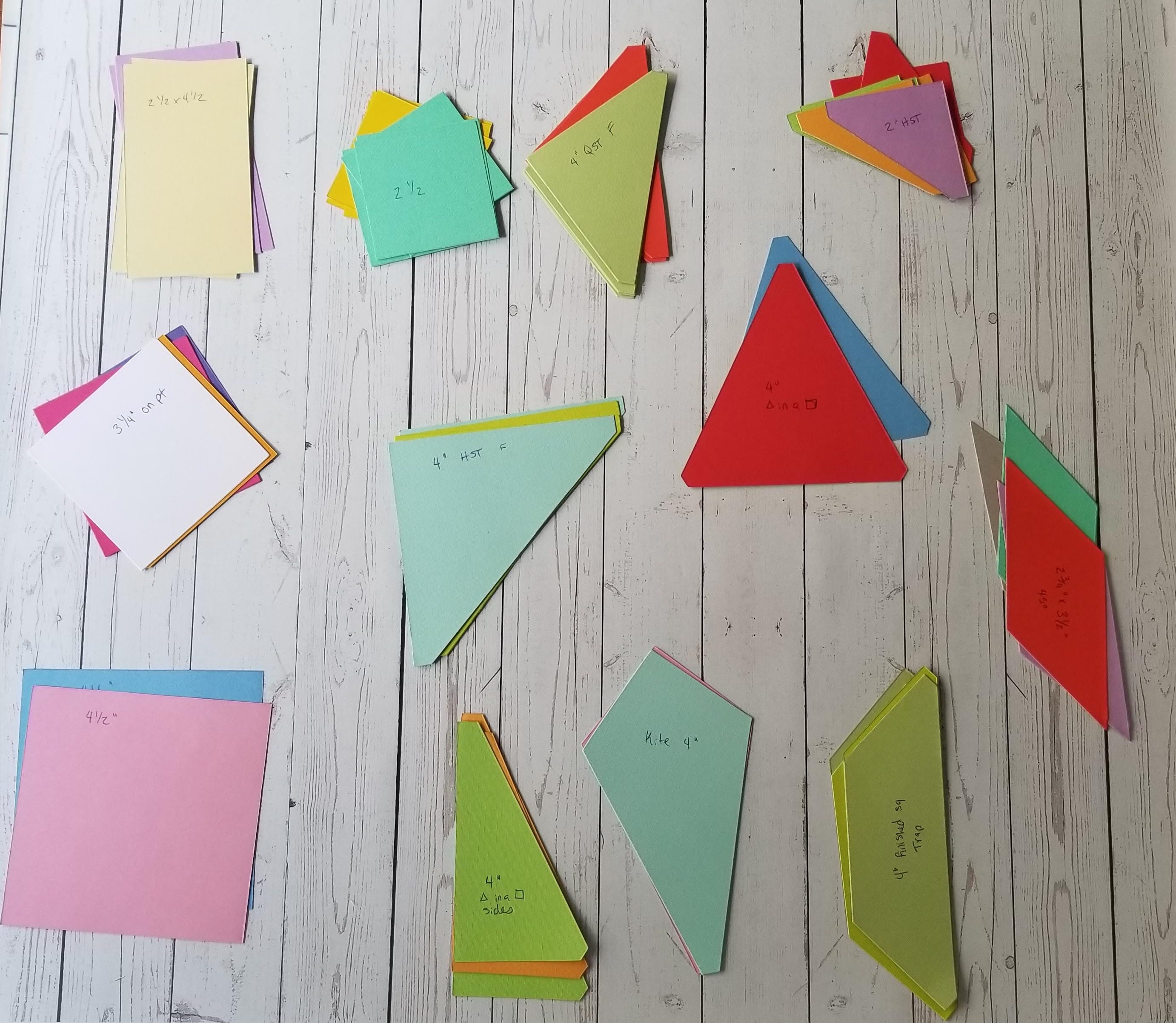 Multicolored cardstock shapes with on wood backdrop