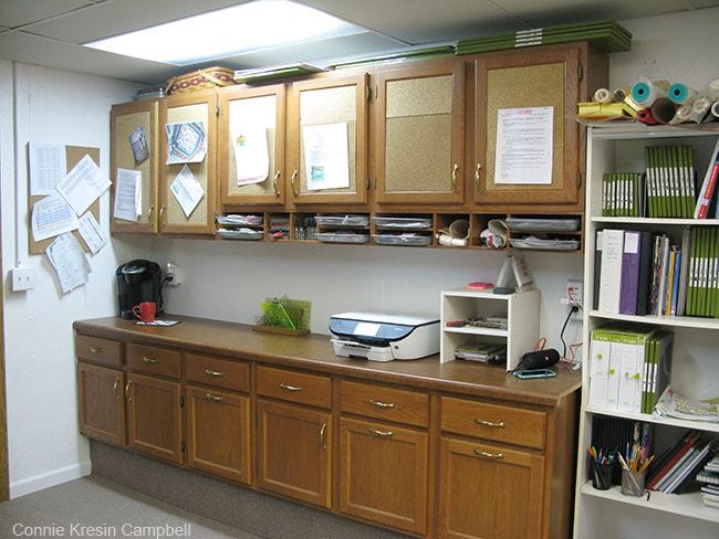 Cabinets in quilt room and large AccuQuilt dies on top