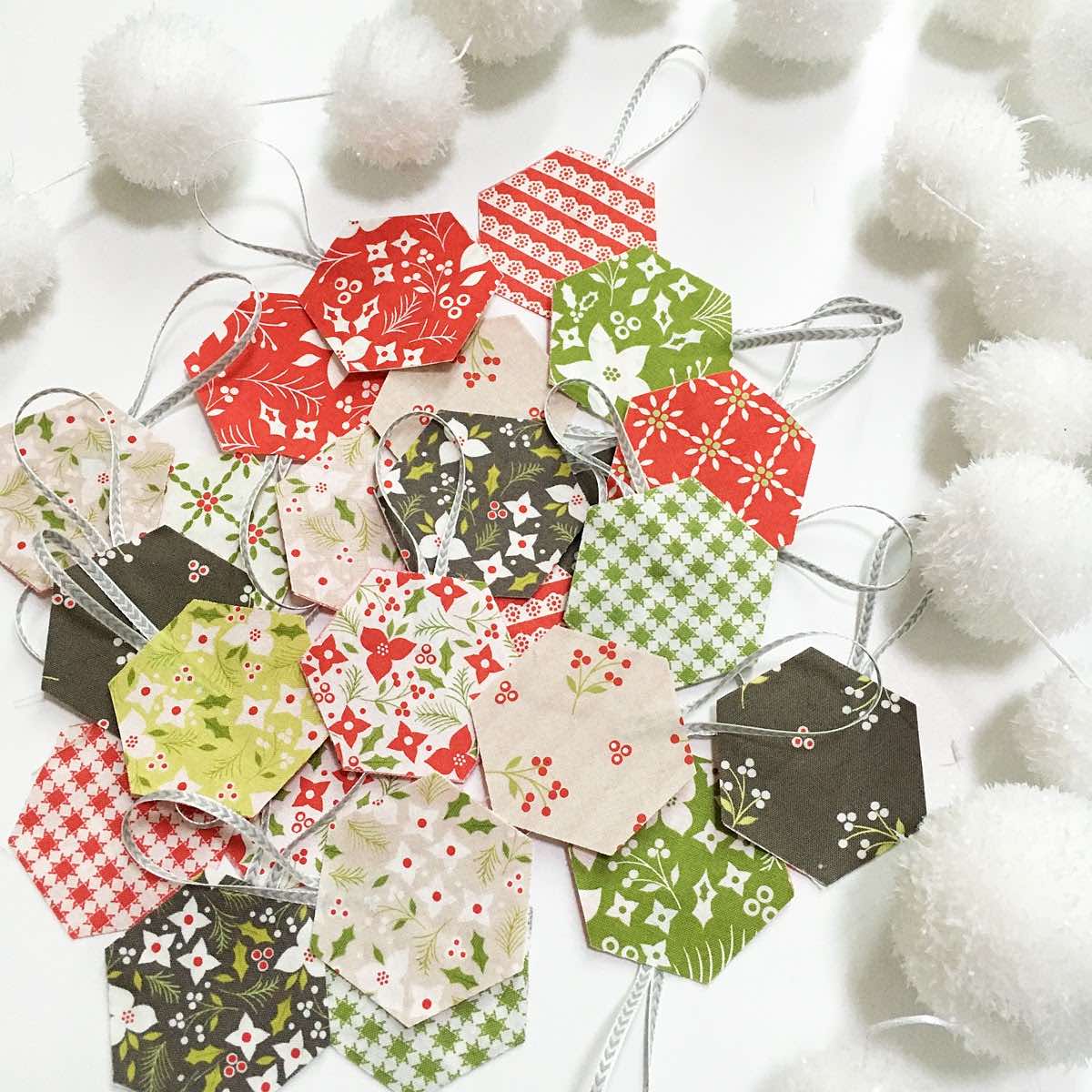 8-perfectly hexagons cut for ornaments next to white garland