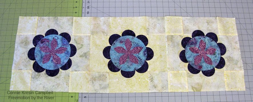 Fuse the AccuQuilt GO! flowers to the table runner