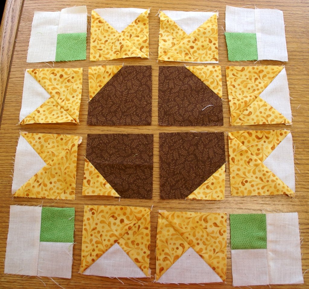 sunflower block laid out on sewing table before sewn together