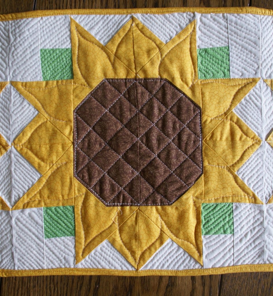 close up of completed sunflower block with detailed quilting