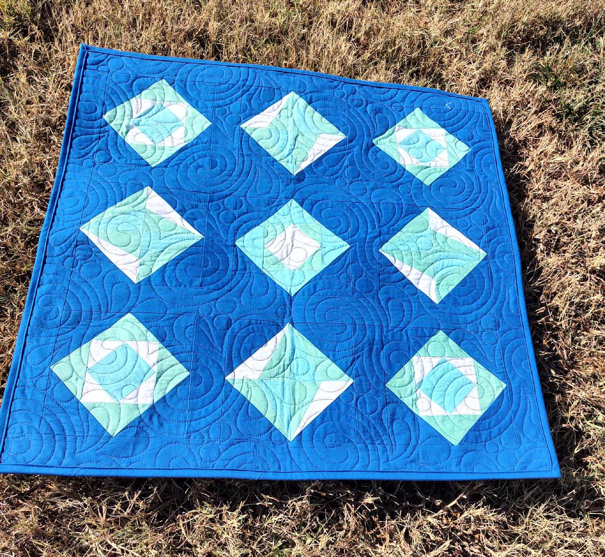 Finished Diamond and Chinese Lanterns Quilt On Grass