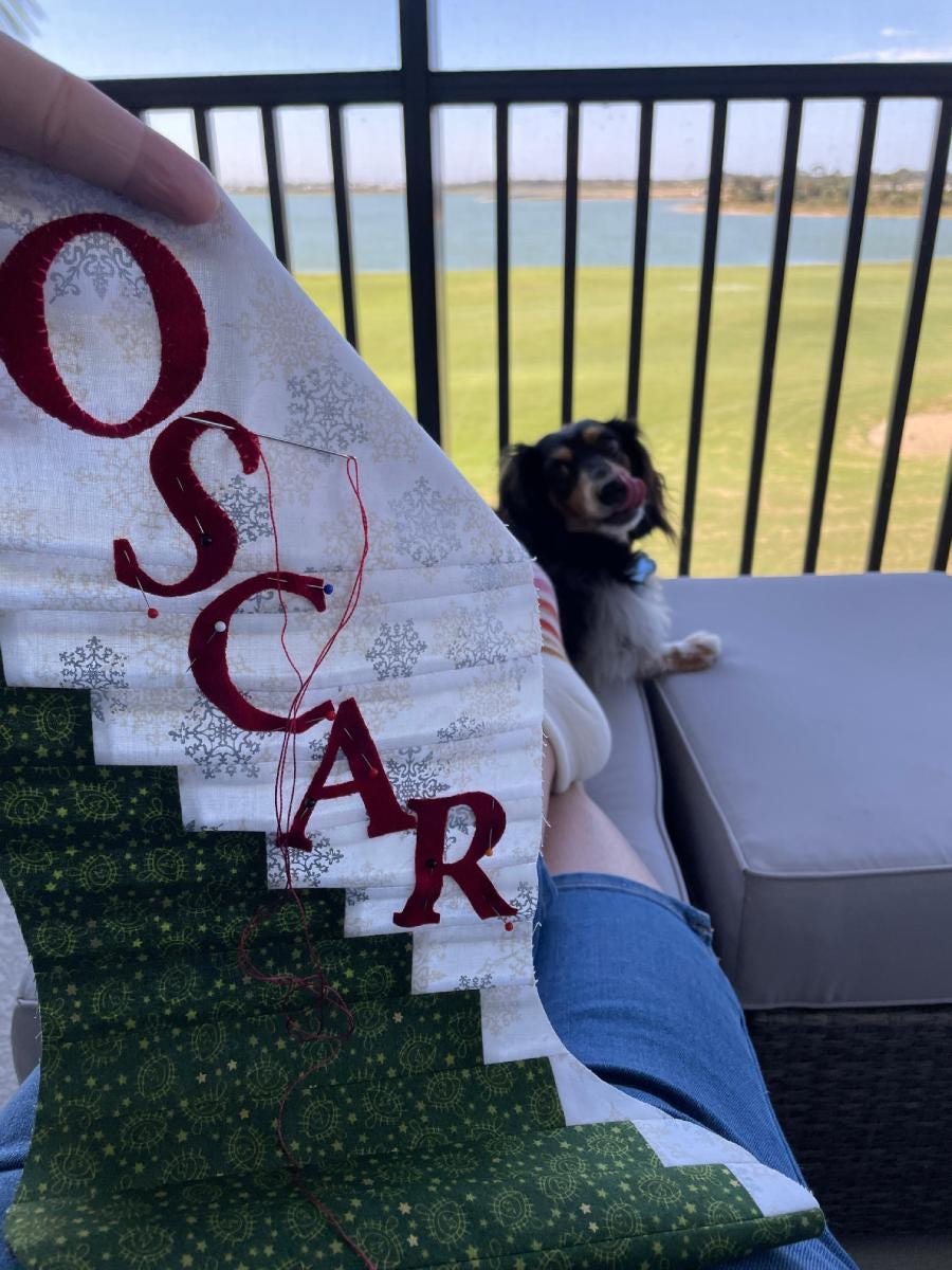 Jen Whip Stitching the Scrappy Stocking with Her Dog