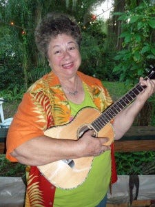 Mary holding her new Oscar Schmidt baritone ukulele