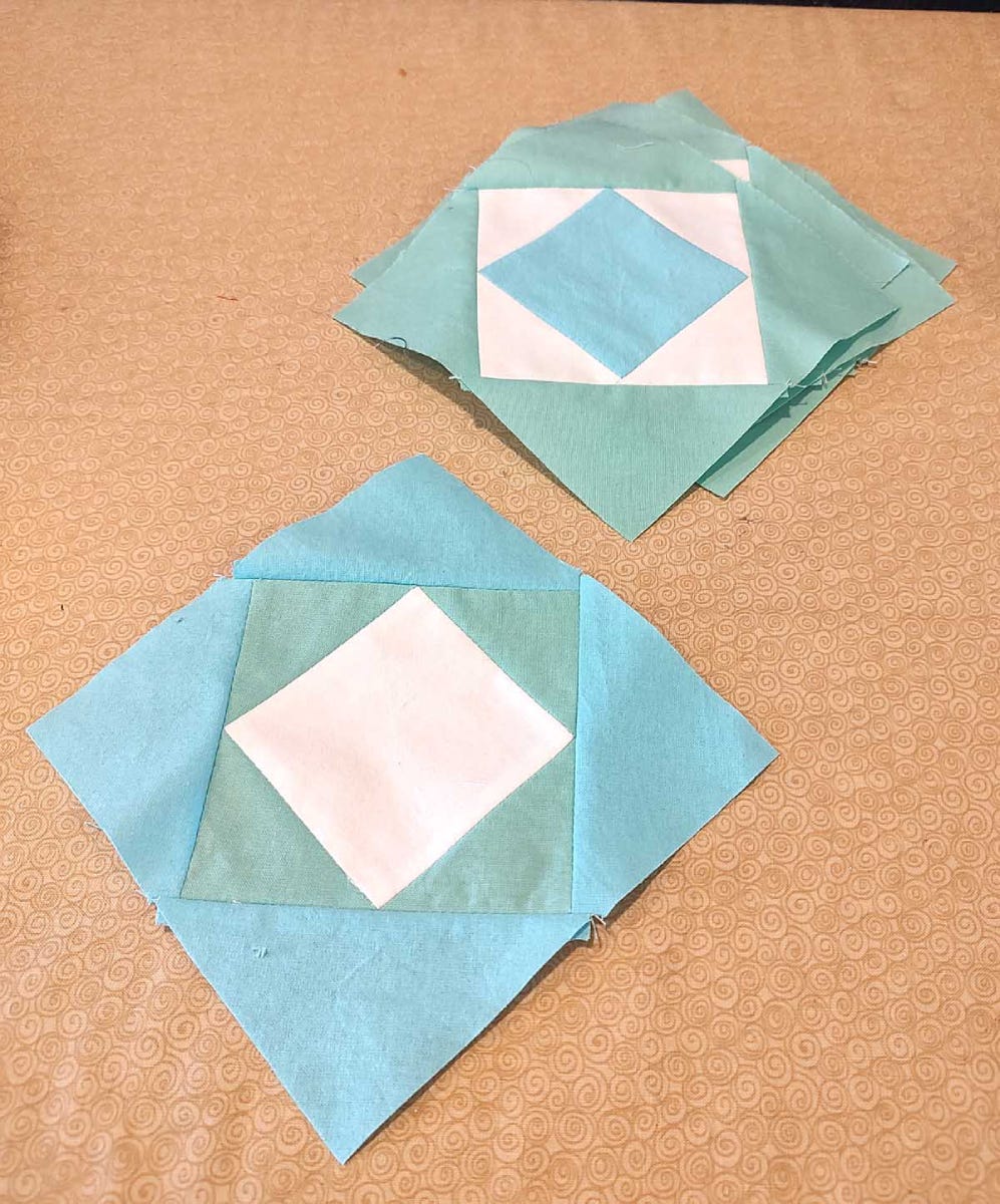 Turquoise Triangles Sewn to the Square in a Square Blocks