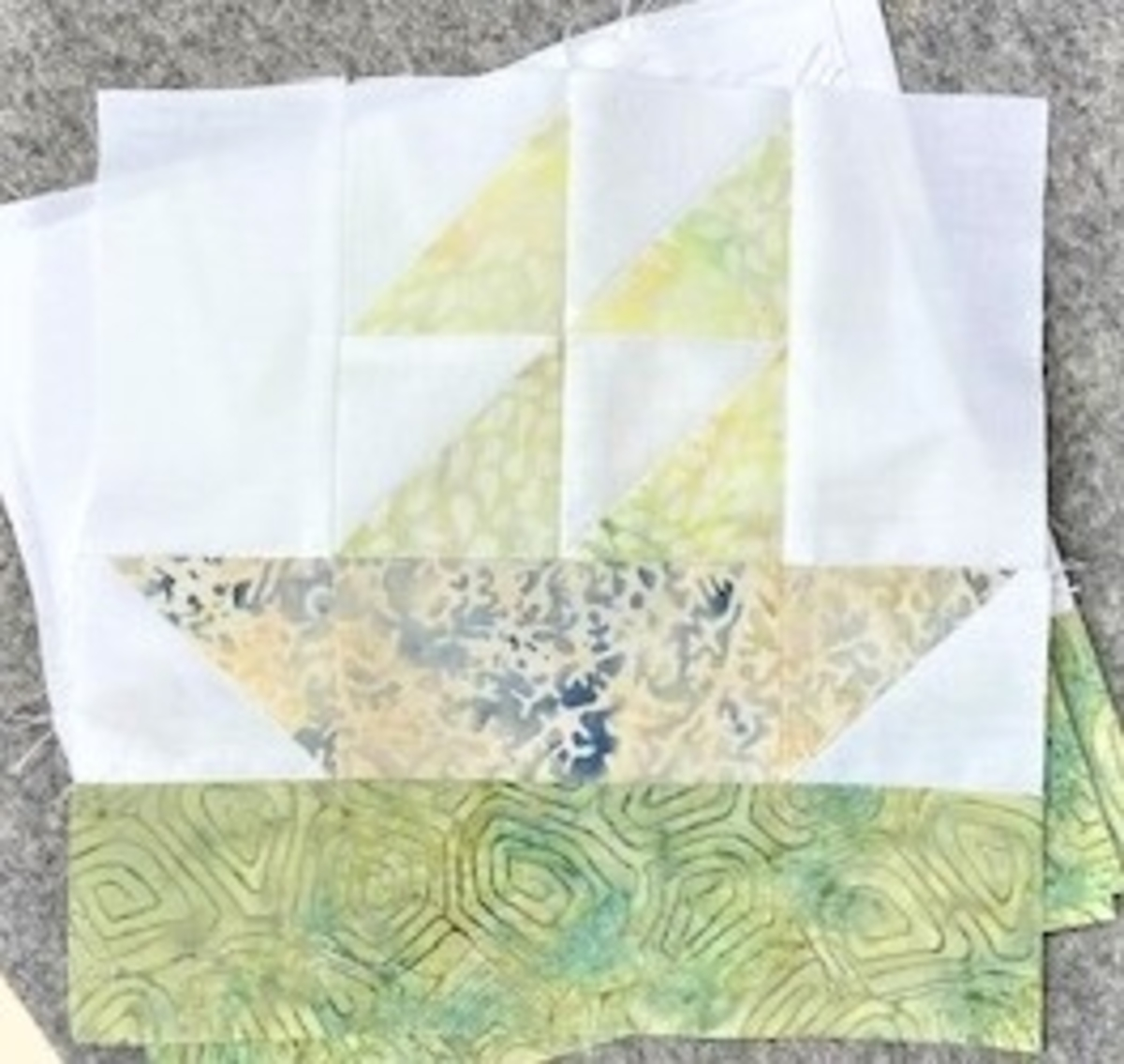 pieced sailboat quilt block made with accuquilt go! mix & match qube 8" and island batik green, yellow and solid white fabrics